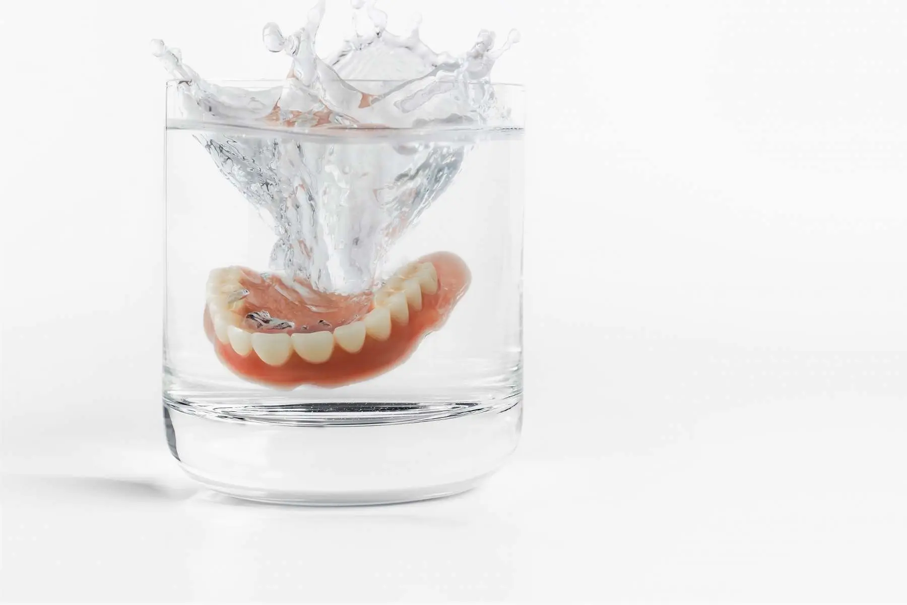 Full denture in a glass of water Chrome Cast denture repairs